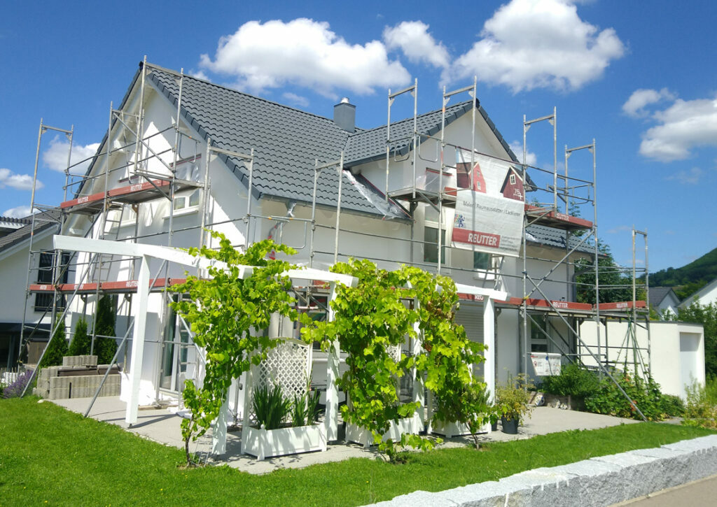 Haus mit Terrasse und Reutter Gerüst davor wird saniert